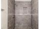 Bathroom shower featuring dark tile, recessed niche, and updated fixtures at 2513 Avenue B # B, Bradenton Beach, FL 34217