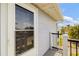Side door featuring a storm door, gray siding and a black metal railing at 2513 Avenue B # B, Bradenton Beach, FL 34217