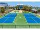Aerial showcases well-maintained tennis and basketball courts with picnic area and landscaping at 2513 Avenue B # B, Bradenton Beach, FL 34217