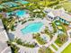 Aerial view of pools and clubhouse with chairs and tropical landscaping in a beautiful community at 2565 Star Apple Way, Sarasota, FL 34240