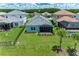 Aerial view of a home with a screened patio in a neighborhood with mature trees and landscaping at 2565 Star Apple Way, Sarasota, FL 34240