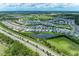 An aerial shot displays an entire neighborhood and a small glimpse of the highway nearby at 2565 Star Apple Way, Sarasota, FL 34240