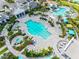 Aerial view of pool and clubhouse with lounge chairs and tropical landscaping in this beautiful community at 2565 Star Apple Way, Sarasota, FL 34240