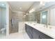 Spacious bathroom with double vanity, walk-in shower, and tile floors at 2565 Star Apple Way, Sarasota, FL 34240