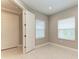 Bedroom with neutral paint, tiled floors, and two windows at 2565 Star Apple Way, Sarasota, FL 34240