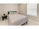 Inviting bedroom featuring a comfortable bed with soft bedding and a bedside table at 2565 Star Apple Way, Sarasota, FL 34240