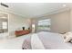 Large bedroom with walk-in closet, neutral tones, tiled floors and king bed at 2565 Star Apple Way, Sarasota, FL 34240