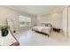Cozy bedroom with a view of the lake, neutral paint and tile floors at 2565 Star Apple Way, Sarasota, FL 34240