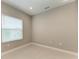 This bedroom features neutral paint, tiled floors, and a window at 2565 Star Apple Way, Sarasota, FL 34240