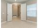 Bright bedroom with neutral walls, tile floors, and an open closet for easy access at 2565 Star Apple Way, Sarasota, FL 34240