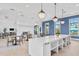 Spacious common area with a white quartz island, high ceilings, and stylish decor at 2565 Star Apple Way, Sarasota, FL 34240