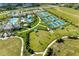 Aerial view showcasing resort-style community amenities, including a pool, tennis courts, and clubhouse at 2565 Star Apple Way, Sarasota, FL 34240