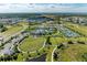Aerial view showcasing resort-style community amenities, including a pool, tennis courts, and clubhouse at 2565 Star Apple Way, Sarasota, FL 34240