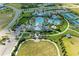 Aerial view showcasing resort-style community amenities, including a pool, tennis courts, and clubhouse at 2565 Star Apple Way, Sarasota, FL 34240
