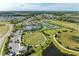 Aerial view showcasing resort-style community amenities, including a pool, tennis courts, and clubhouse at 2565 Star Apple Way, Sarasota, FL 34240