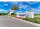 Elegant community entrance with lush landscaping and a welcoming Windward Lakewood Ranch sign at 2565 Star Apple Way, Sarasota, FL 34240