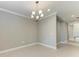 Empty dining room with elegant chandelier and a view to the hallway in a home at 2565 Star Apple Way, Sarasota, FL 34240