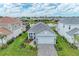 Beautiful single Gathering home featuring a gray tile roof, paver driveway, and a well maintained lawn with landscaped accents at 2565 Star Apple Way, Sarasota, FL 34240