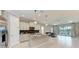 Open floor plan showcasing modern kitchen with stainless appliances, granite countertops, and backyard view at 2565 Star Apple Way, Sarasota, FL 34240
