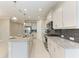 Modern kitchen features stainless appliances, granite countertops, and subway tile backsplash at 2565 Star Apple Way, Sarasota, FL 34240