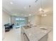 Kitchen island has granite countertops, stainless steel faucet, and views to the outdoor landscape at 2565 Star Apple Way, Sarasota, FL 34240