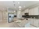 Kitchen includes stainless steel appliances, granite countertops, and a central island at 2565 Star Apple Way, Sarasota, FL 34240