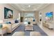 Bright living room boasts lots of natural light, modern decor, and a sliding door with a backyard view at 2565 Star Apple Way, Sarasota, FL 34240