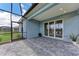 Covered outdoor brick patio with a screened enclosure, providing an amazing outdoor entertainment area at 2565 Star Apple Way, Sarasota, FL 34240