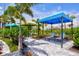 Outdoor covered lounge area with lounge chairs surrounded by greenery in a community at 2565 Star Apple Way, Sarasota, FL 34240