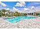 Beautiful pool with lounge chairs and clubhouse in the background in a great community at 2565 Star Apple Way, Sarasota, FL 34240