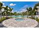 Pool with a spa and a clubhouse surrounded with palm trees in a lovely community at 2565 Star Apple Way, Sarasota, FL 34240