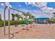 A swing set near a shaded seating area offers a relaxing place to unwind and enjoy the outdoors at 2565 Star Apple Way, Sarasota, FL 34240