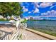 Scenic waterfront view featuring a swan bicycle planter, water, and city skyline at 2565 Star Apple Way, Sarasota, FL 34240