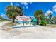 Colorful welcome sign to Holmes Beach on Anna Maria Island, framed by palm trees and a blue sky at 2565 Star Apple Way, Sarasota, FL 34240