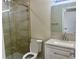 Bathroom featuring tiled glass shower, toilet, vanity with quartz countertop, and updated fixtures at 2636 Hidden Lake N Dr # G, Sarasota, FL 34237