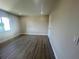 Bedroom with wood-look floors, a window, and neutral-painted walls at 2636 Hidden Lake N Dr # G, Sarasota, FL 34237