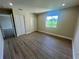 Bedroom with wood-look floors, a window, and a double closet at 2636 Hidden Lake N Dr # G, Sarasota, FL 34237