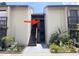 Condo entrance with stairs leading to the unit and well-maintained landscaping at 2636 Hidden Lake N Dr # G, Sarasota, FL 34237