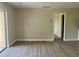 Open-concept living room featuring wood-look flooring and access to a patio at 2636 Hidden Lake N Dr # G, Sarasota, FL 34237