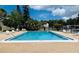 Community swimming pool with lounge chairs at 2636 Hidden Lake N Dr # G, Sarasota, FL 34237