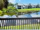 Community buildings reflected in a pond, seen from a patio at 2636 Hidden Lake N Dr # G, Sarasota, FL 34237