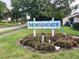 Community sign that says Morningside, surrounded by mature trees and manicured landscaping at 2904 64Th W St # 2904, Bradenton, FL 34209