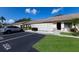 Exterior view showcasing villa, guest parking, partial privacy fence, and meticulously kept landscaping at 2904 64Th W St # 2904, Bradenton, FL 34209
