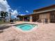 Exterior view of hot tub with blue water, lounge chairs, tables, and umbrellas nearby at 2904 64Th W St # 2904, Bradenton, FL 34209