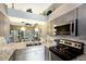 Bright kitchen showcasing stainless steel appliances, granite counters, and easy access to the living area at 2904 64Th W St # 2904, Bradenton, FL 34209