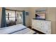 Another angle of main bedroom with a beach view paintings and access to office space at 2904 64Th W St # 2904, Bradenton, FL 34209