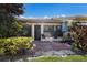 Comfortable outdoor patio with a table, chairs, an umbrella, and mature landscaping at 2904 64Th W St # 2904, Bradenton, FL 34209