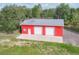 Aerial view of the garage building, showcasing its metal roof, two garage doors and surrounding property at 3045 Logue Rd, Myakka City, FL 34251