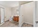 Bright bathroom with a glass-enclosed shower, wood vanity, and convenient access to the laundry area at 3045 Logue Rd, Myakka City, FL 34251