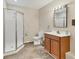 Well-lit bathroom featuring a glass-enclosed shower and a vanity with a sink and storage at 3045 Logue Rd, Myakka City, FL 34251
